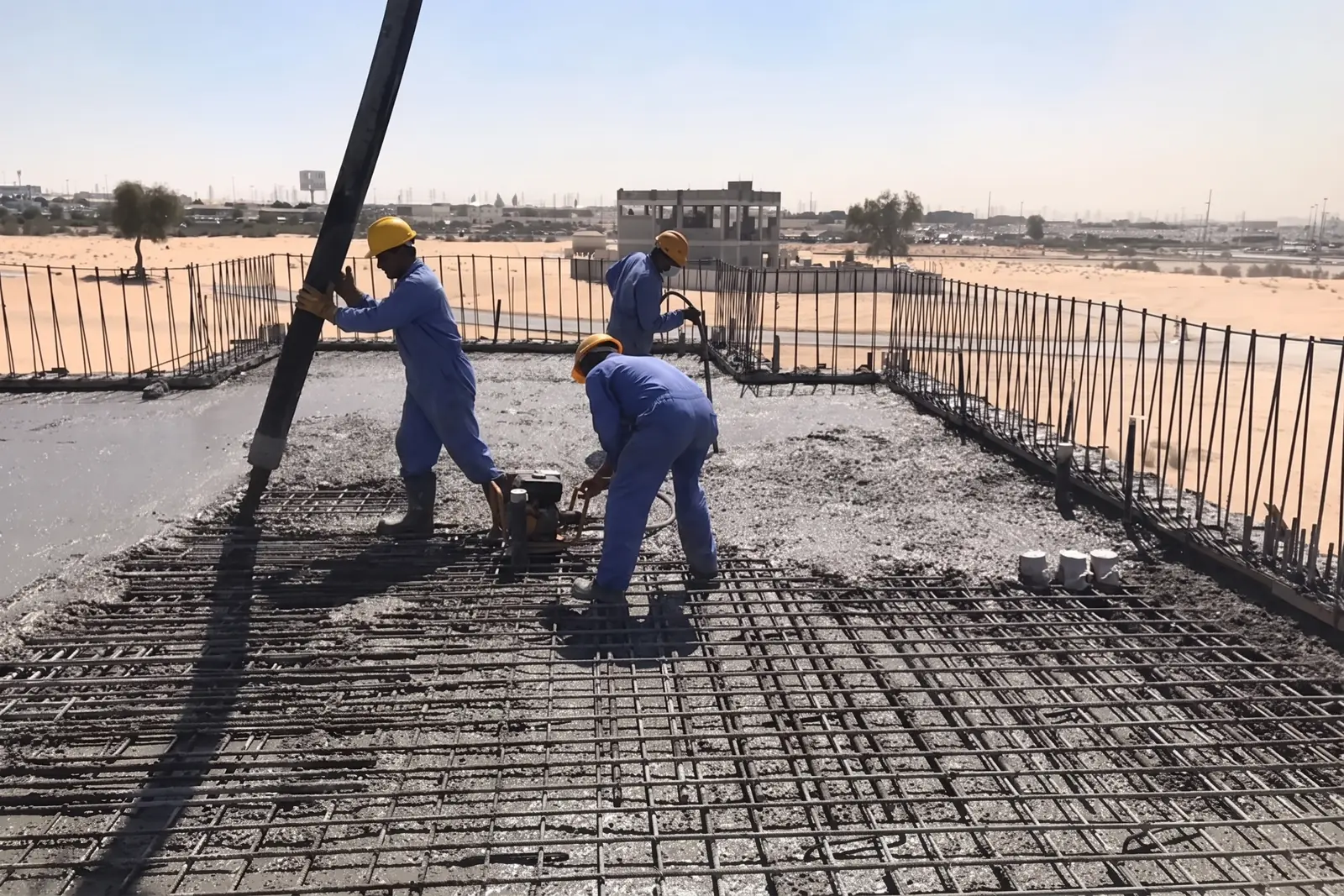 A Miles crew placing concrete to a reinforced slab